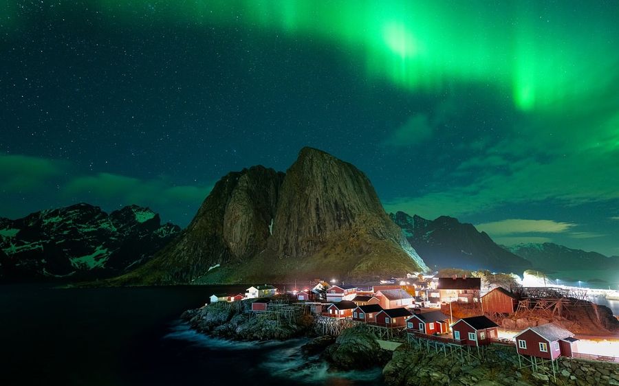 Northern lights over a fishing village in the Lofoten Islands, Norway