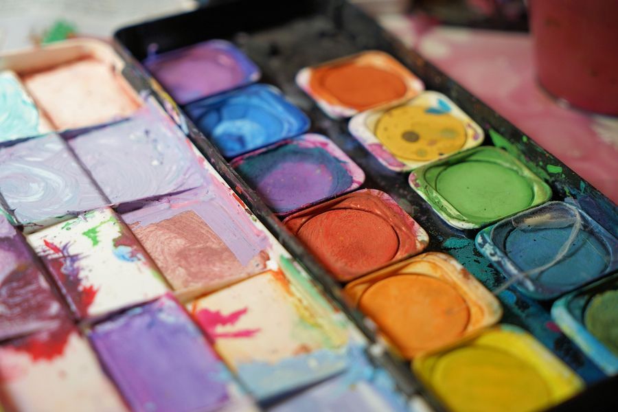 A tray of watercolor paints in many colors
