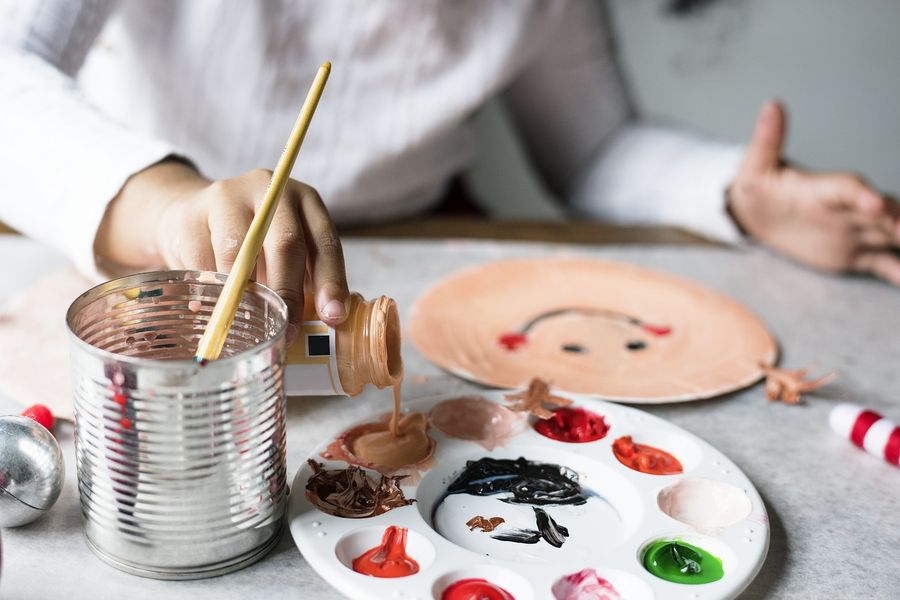 A child painting with a brush at a table