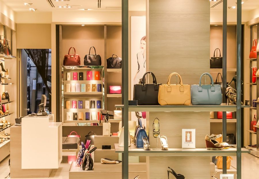 Handbags and shoes on shelves in a boutique